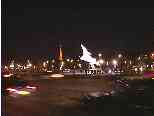 A Rafale fighter mounted on a plinth at end of Champs Elysee.  (Eiffel Tower in background.)